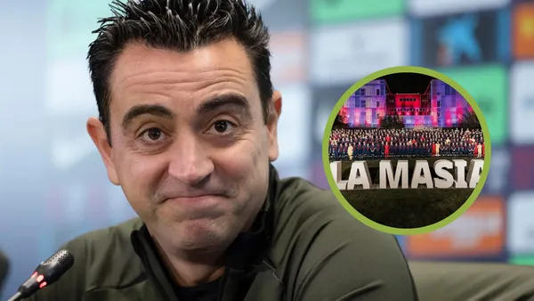 Xavi se sonríe en rueda de prensa, a su izquierda La Masía.
