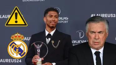 Jude Bellingham ganador del Premio Laureus. Ancelotti serio, escudo del Real Madrid y logo de advertencia.